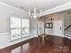 Open-concept dining space with crown molding, large window, and adjacent foyer at 2369 Baxter Se Pl, Concord, NC 28025