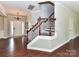 Spacious entryway featuring hardwood floors, a staircase, and a chandelier above the front door at 2369 Baxter Se Pl, Concord, NC 28025