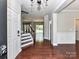 Inviting foyer showcasing hardwood floors, staircase, and open view to living areas at 2369 Baxter Se Pl, Concord, NC 28025