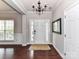 Bright foyer with hardwood floors, white wainscoting, and a chandelier at 2369 Baxter Se Pl, Concord, NC 28025
