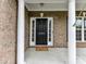 View of the front door with white columns and sidelights, showing the house number 2369 at 2369 Baxter Se Pl, Concord, NC 28025