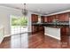 Spacious kitchen features dark cabinets, granite counters, stainless appliances, and access to the backyard at 2369 Baxter Se Pl, Concord, NC 28025