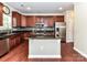 Kitchen featuring dark cabinets, granite countertops, stainless steel appliances, and a kitchen island at 2369 Baxter Se Pl, Concord, NC 28025