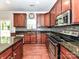 Kitchen featuring dark cabinets, granite countertops, stainless steel appliances and black tiled backsplash at 2369 Baxter Se Pl, Concord, NC 28025