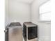Modern laundry room featuring front load Samsung washer and dryer at 2369 Baxter Se Pl, Concord, NC 28025
