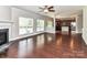 Open-concept living room with hardwood floors, fireplace, and seamless transition to the kitchen at 2369 Baxter Se Pl, Concord, NC 28025