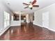 Open-concept living room features hardwood floors and flows into the kitchen with stainless steel appliances at 2369 Baxter Se Pl, Concord, NC 28025