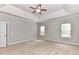 This spacious main bedroom features a trey ceiling, ceiling fan, and large windows for natural light at 2369 Baxter Se Pl, Concord, NC 28025