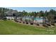 Community pool area with black fence, lounge chairs, and sunbathing area, set amongst mature trees at 2369 Baxter Se Pl, Concord, NC 28025