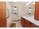 Well-lit bathroom features a shower and tub combo and a wooden vanity with ample counter space at 2412 Wedgewood Dr, Salisbury, NC 28146