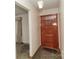 Front entryway featuring a beautiful solid wood door with decorative design elements and carpet floor at 2412 Wedgewood Dr, Salisbury, NC 28146