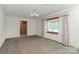 Bright living room with large window and neutral carpeting, ready for personal touches at 2412 Wedgewood Dr, Salisbury, NC 28146