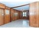 Living room with wood paneling, tile floors, and natural light at 2412 Wedgewood Dr, Salisbury, NC 28146