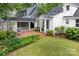 Spacious backyard with a brick patio, lush lawn, and garden area perfect for entertaining at 3020 Hampton Ave, Charlotte, NC 28207