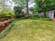 Expansive backyard featuring a well-kept lawn, mature trees, and beautiful landscaping at 3020 Hampton Ave, Charlotte, NC 28207