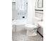 Clean bathroom featuring black and white tiled floors and a combined shower and tub at 3020 Hampton Ave, Charlotte, NC 28207