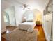 Bright bedroom featuring sloped ceilings, wood floors, a ceiling fan, and built-in storage at 3020 Hampton Ave, Charlotte, NC 28207