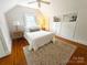 Bright bedroom featuring sloped ceilings, wood floors, a ceiling fan, and built-in storage at 3020 Hampton Ave, Charlotte, NC 28207