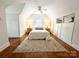 Bright bedroom featuring sloped ceilings, wood floors, a ceiling fan, and built-in storage at 3020 Hampton Ave, Charlotte, NC 28207