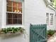 Charming home exterior features a window box with vibrant flowers and a picket fence gate at 3020 Hampton Ave, Charlotte, NC 28207