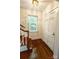 Inviting foyer featuring hardwood floors, a window with white shutters, and a classic paneled front door at 3020 Hampton Ave, Charlotte, NC 28207