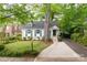 Home with a well-manicured lawn, mature trees, and a concrete driveway at 3020 Hampton Ave, Charlotte, NC 28207