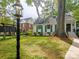 Inviting front yard with lush lawn, mature trees, and charming home with green shutters at 3020 Hampton Ave, Charlotte, NC 28207
