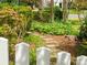 Beautiful front yard featuring a stone pathway, colorful flowers, and well-manicured bushes at 3020 Hampton Ave, Charlotte, NC 28207