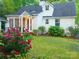 Charming home with a well-maintained lawn, flowering bushes, and inviting front porch at 3020 Hampton Ave, Charlotte, NC 28207
