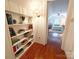 Hallway featuring built-in bookshelves leading to a bedroom with a view of a bed at 3020 Hampton Ave, Charlotte, NC 28207