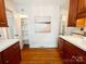 Bright kitchen with hardwood floors, white countertops, modern art, and ample cabinet space at 3020 Hampton Ave, Charlotte, NC 28207