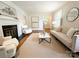 Cozy living room showcasing hardwood floors, a fireplace, and stylish neutral-toned furniture at 3020 Hampton Ave, Charlotte, NC 28207