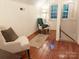 Cozy sitting area with wainscoting, hardwood floors, and comfortable armchairs by a window at 3020 Hampton Ave, Charlotte, NC 28207