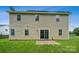 Exterior of the home featuring a siding exterior, glass sliding door, and a grassy lawn at 3038 Twin Peaks Ct, Monroe, NC 28110