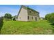 Large backyard with green grass, vinyl siding, and sliding glass doors to the home at 3038 Twin Peaks Ct, Monroe, NC 28110