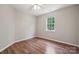 Bedroom featuring a window, hardwood floors, neutral walls, and ample natural light at 3038 Twin Peaks Ct, Monroe, NC 28110
