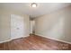 Bright bedroom features wood-look flooring and double door closet for ample storage at 3038 Twin Peaks Ct, Monroe, NC 28110