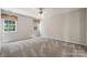 Cozy bedroom with carpet, ceiling fan, and dual windows for natural light at 3038 Twin Peaks Ct, Monroe, NC 28110