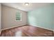 Bedroom with hardwood flooring, neutral walls, window, and ample natural light at 3038 Twin Peaks Ct, Monroe, NC 28110