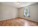 Bedroom with hardwood flooring, neutral walls, and a window that provides natural light at 3038 Twin Peaks Ct, Monroe, NC 28110
