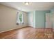 Bedroom with hardwood flooring, neutral walls, window, and a white door to the closet at 3038 Twin Peaks Ct, Monroe, NC 28110