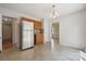 Bright kitchen with stainless steel refrigerator and beautiful chandelier lighting fixture at 3038 Twin Peaks Ct, Monroe, NC 28110