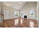 Bright living room features a fireplace, hardwood floors, and large windows at 3038 Twin Peaks Ct, Monroe, NC 28110
