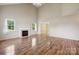 Bright living room with fireplace, tall ceilings, and wood flooring throughout at 3038 Twin Peaks Ct, Monroe, NC 28110
