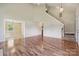 Spacious living room with hardwood floors, tall ceilings, and staircase access at 3038 Twin Peaks Ct, Monroe, NC 28110