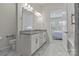 Bright bathroom featuring double sinks, granite countertops and a marble floor at 329 Brambling Ct, Monroe, NC 28110