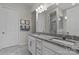Modern bathroom featuring double sinks, granite countertops and a large mirror at 329 Brambling Ct, Monroe, NC 28110