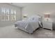 Bright bedroom features a large window and neutral carpet and walls at 329 Brambling Ct, Monroe, NC 28110