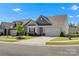 Inviting single-story home with a well-maintained lawn and attached two-car garage on a sunny day at 329 Brambling Ct, Monroe, NC 28110