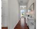 Elegant hallway with hardwood floors, white walls, and a view of the well-manicured front yard at 329 Brambling Ct, Monroe, NC 28110